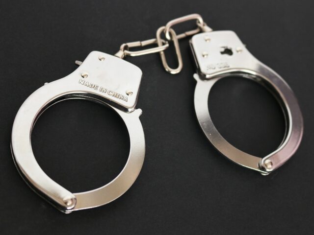 A pair of metal handcuffs on a black background. The handcuffs are connected by a short chain, with "Made in China" engraved on the left side. These restraints serve as a stark reminder of the consequences violent crimes can bring in Pennsylvania and beyond.