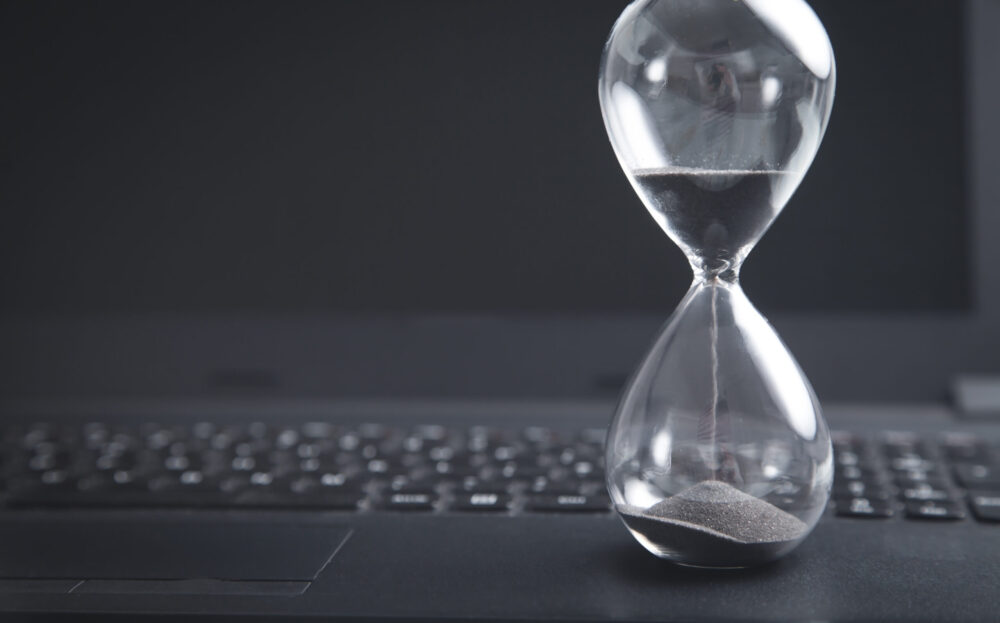 hourglass with laptop