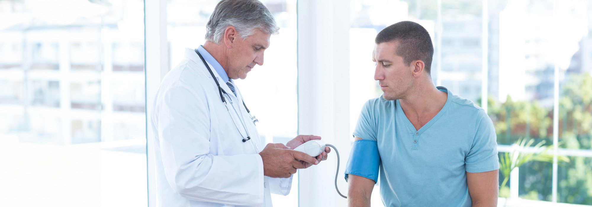 doctor examining his patients blood pressure