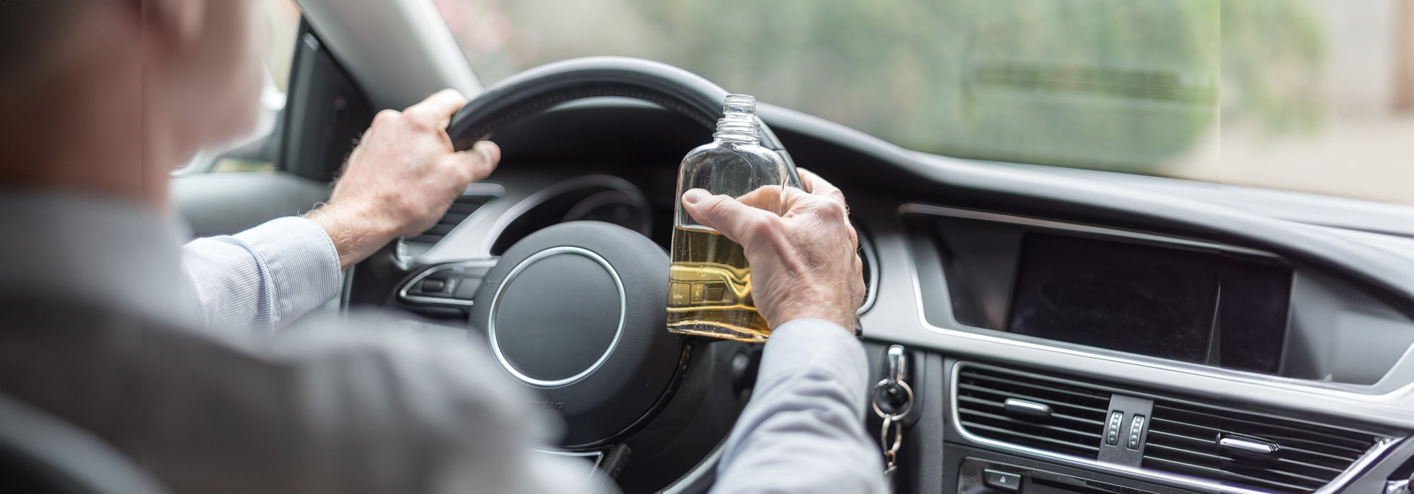 man drinking alcohol and driving