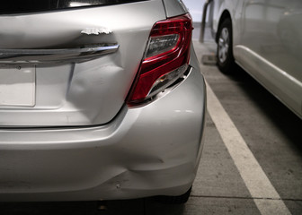 car in parking lot with minor damage to rear