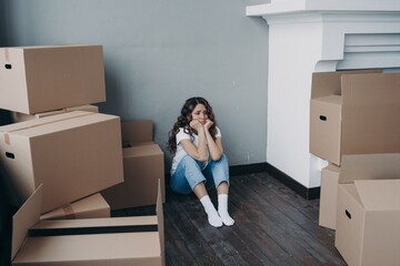 woman looking sad with a bunch of boxes