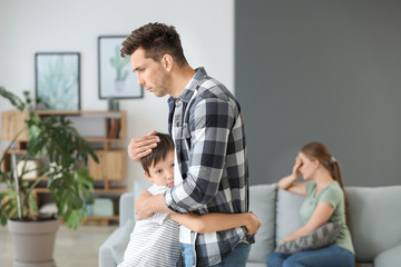 child hugging parent while other watches