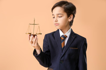 child in suit holding scales of justice