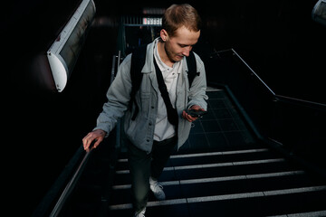 man texting on stairs